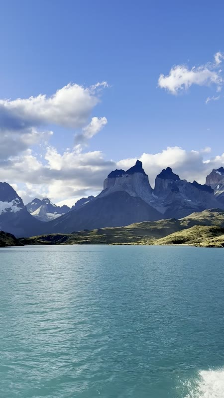 Video from a catamaran crossing turquoise Lago Pehoé, panning from the dark-capped Cuernos del Paine to snowy peaks