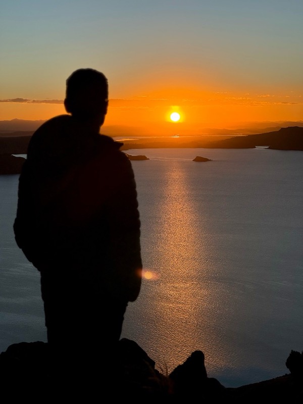 Silhouette watching the sun set over Lake Titicaca from Amantaní Island