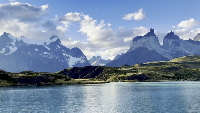 Video across Lago Pehoé to the snowy Paine massif and the dark-capped Cuernos under drifting clouds